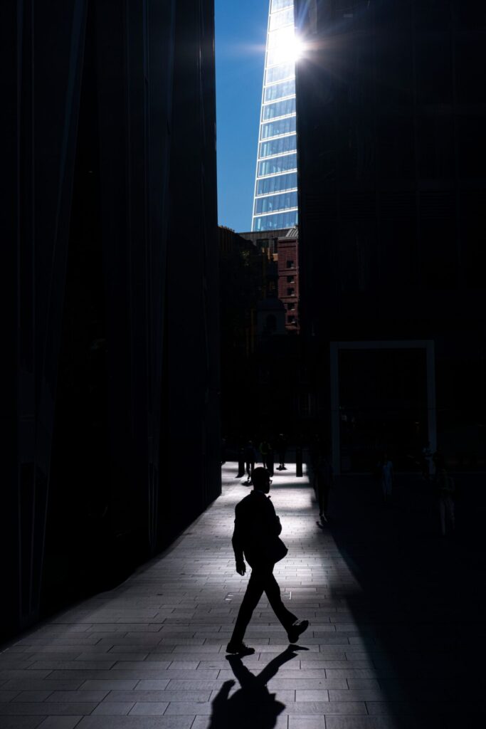 A,Dramatic,Silhouette,Of,A,Person,Walking,In,Shadow,With
