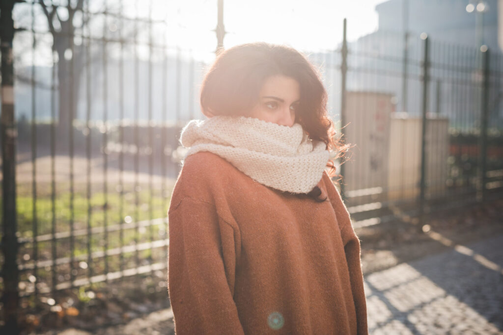 Portrait,Of,Young,Woman,With,Scarf,Covering,Mouth,In,Park