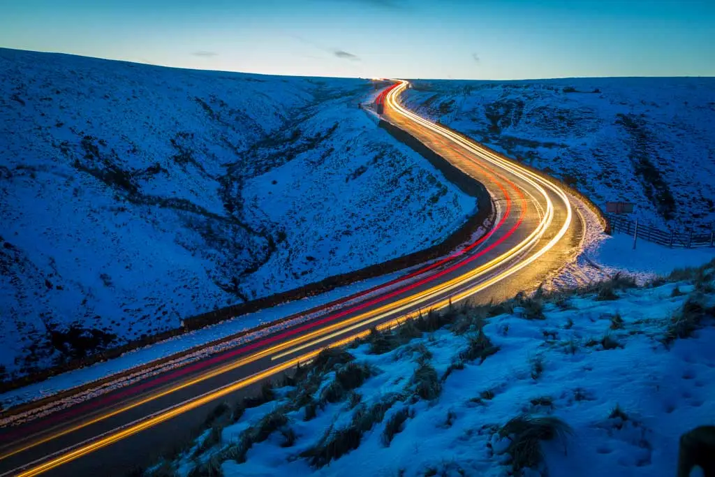 light trail in snowy mountain pass