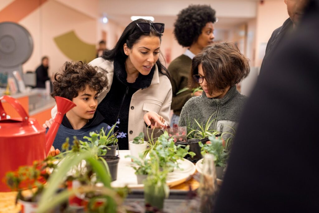 Mother,With,Sons,Buying,Plants,While,Shopping,At,Recycling,Center