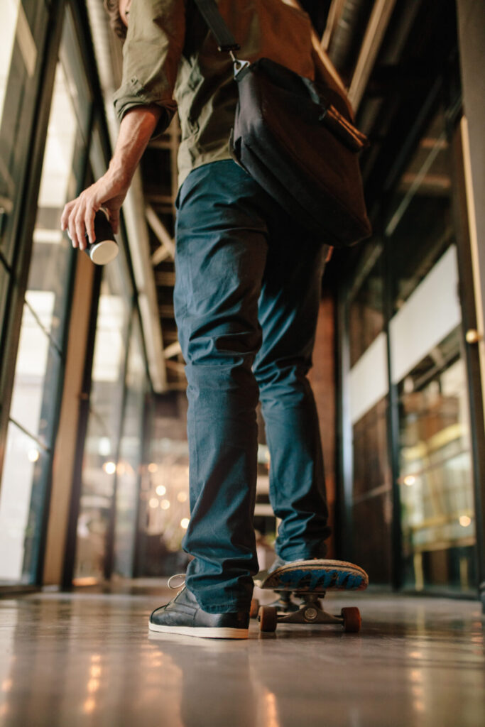 Rear,View,Shot,Of,Man,With,Skateboard,In,Office.,Young