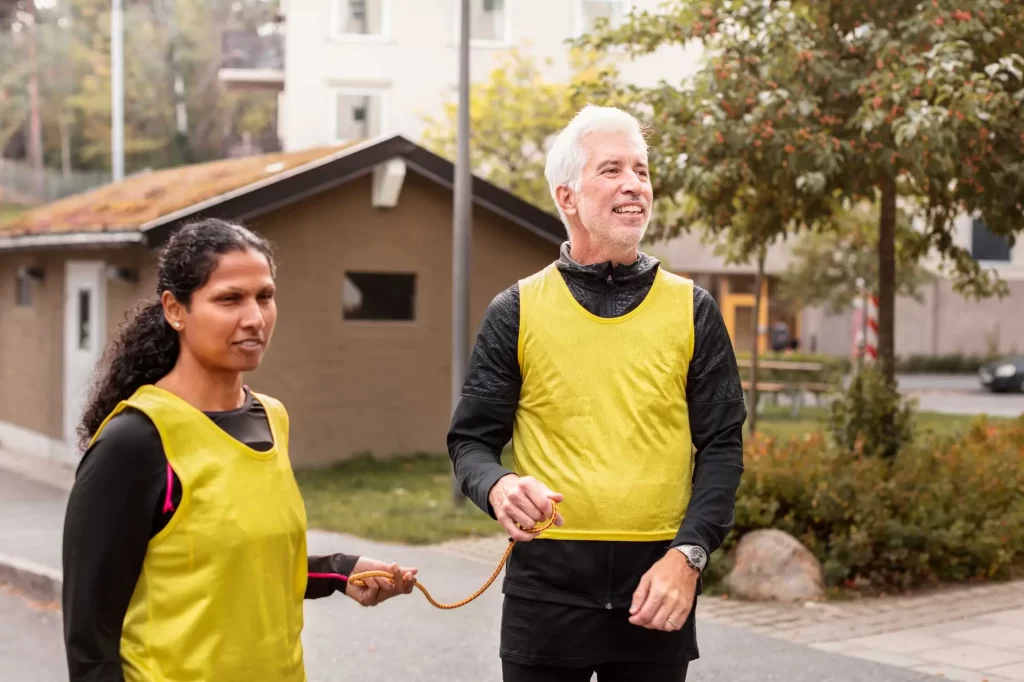 visually impaired woman running with guide offset 1087273