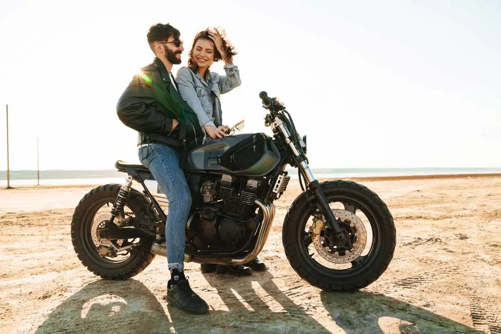 motorcycle couple on beach 1771405073