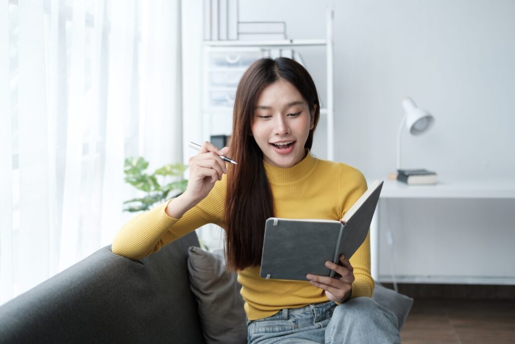 Pretty,Beautiful,Girl,Reading,A,Book,At,Sofa,,Studying,And